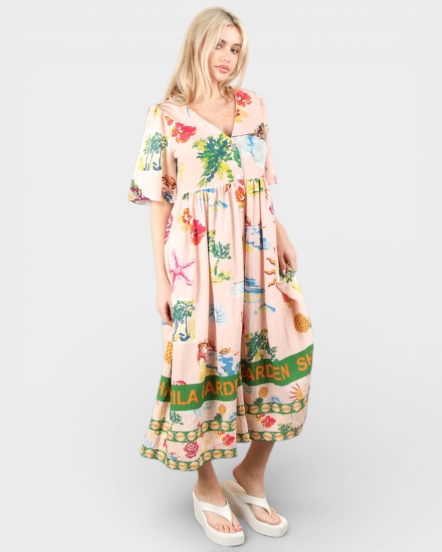 Woman wearing a colorful dress with floral patterns on a white background