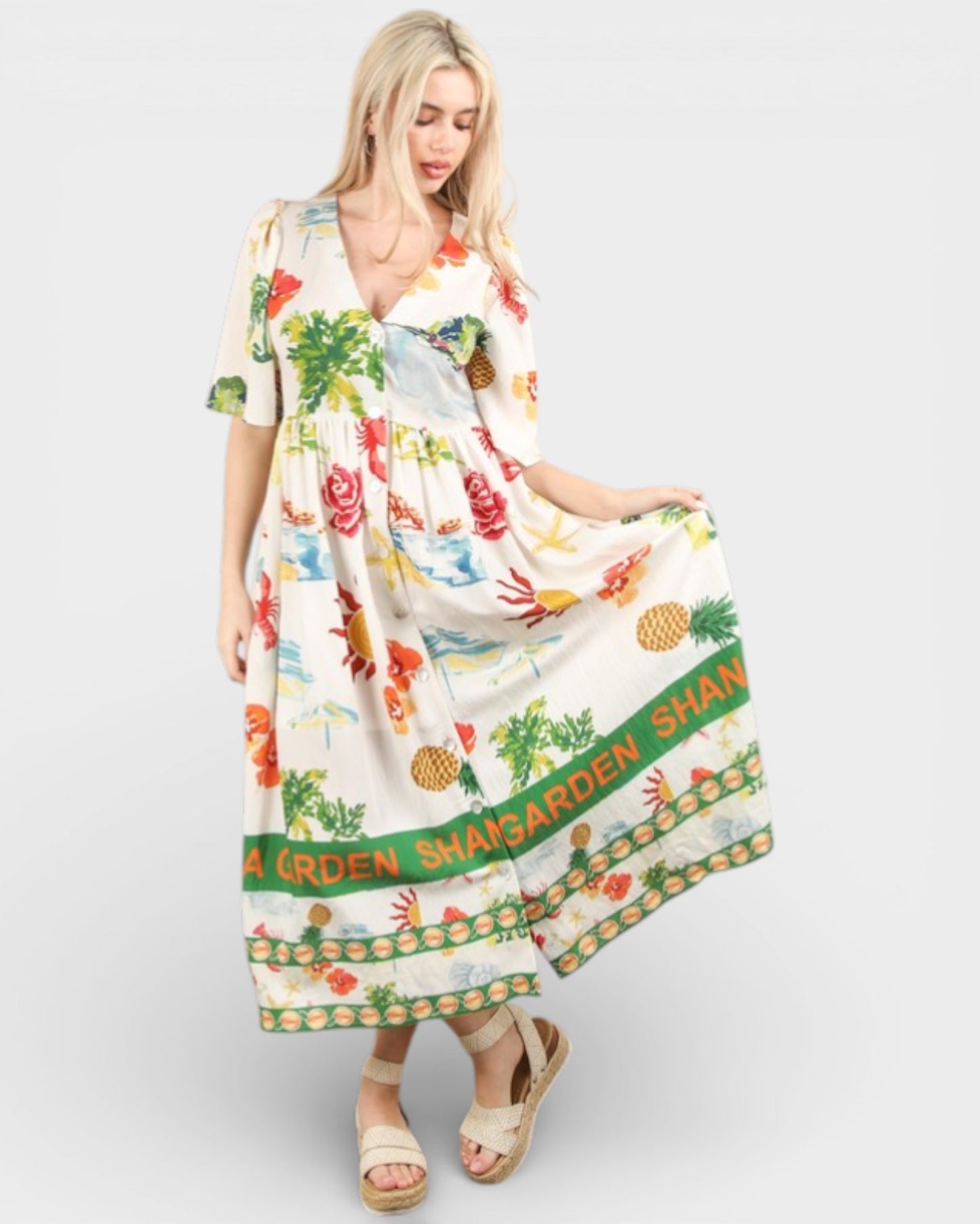 Woman wearing a colorful dress with floral and text design on a white background
