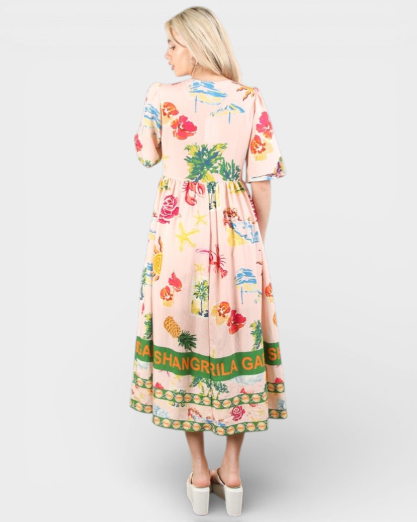 Woman wearing a colorful dress with floral pattern and 'Shangrila Garden' text on a white background