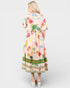 Woman wearing a colorful dress with floral pattern and 'Shangrila Garden' text on a white background