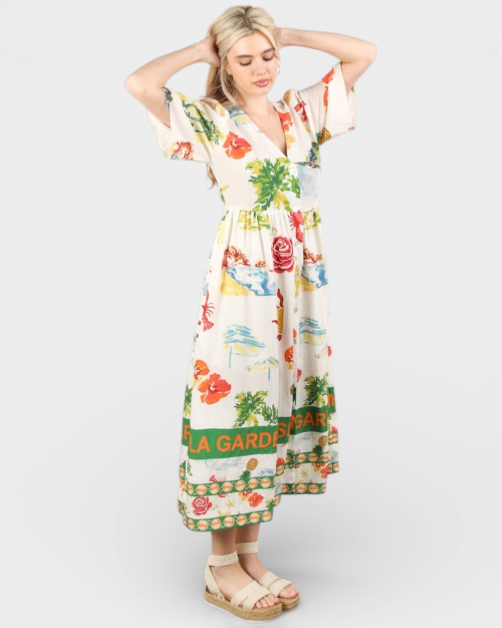 Woman wearing a colorful floral dress with 'Shangri La Garden' text on a white background