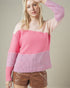 Woman wearing a pink sweater with a plain background