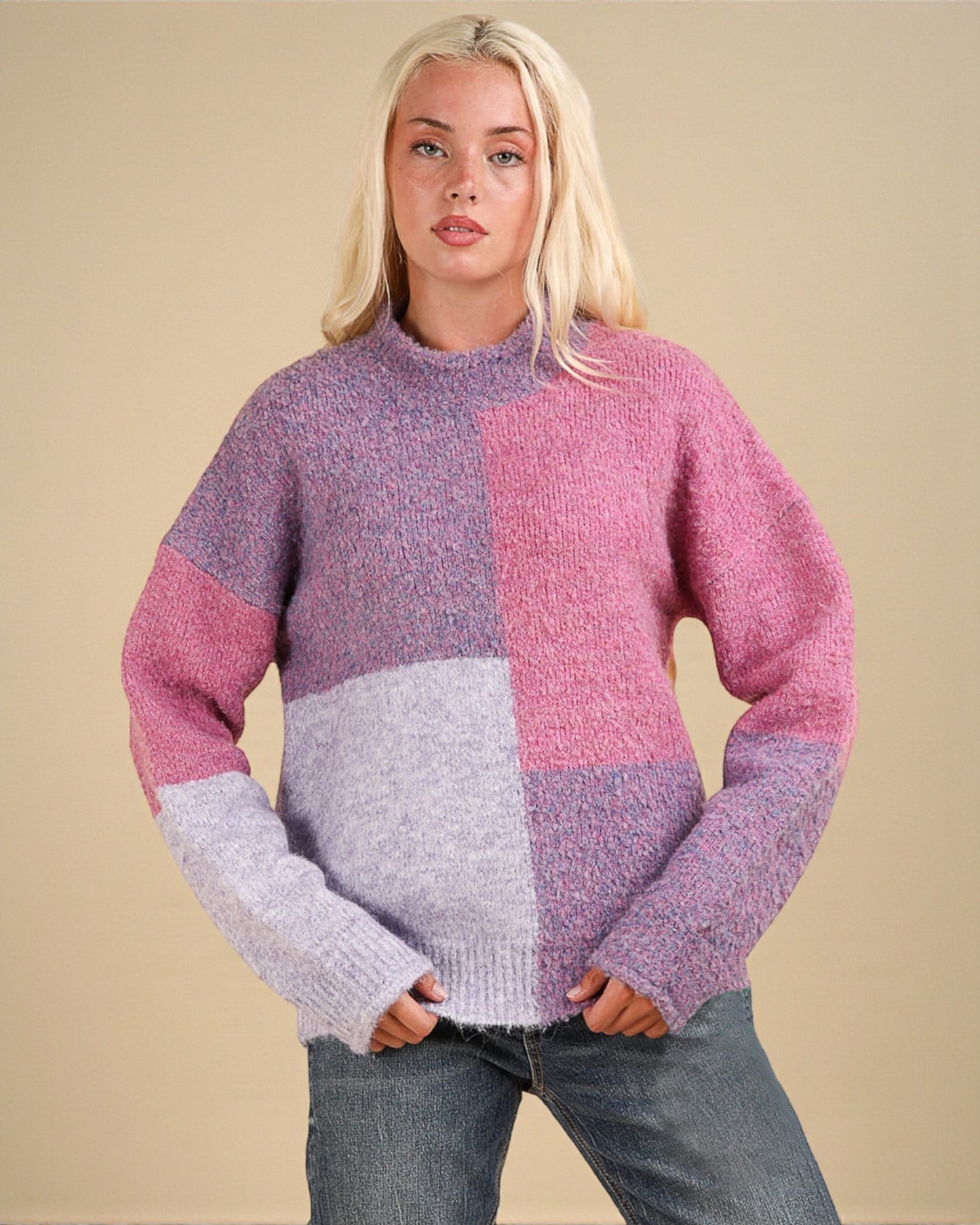 Woman wearing a colorful sweater with a beige background
