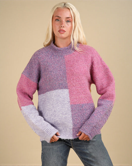 Woman wearing a colorful sweater with a beige background