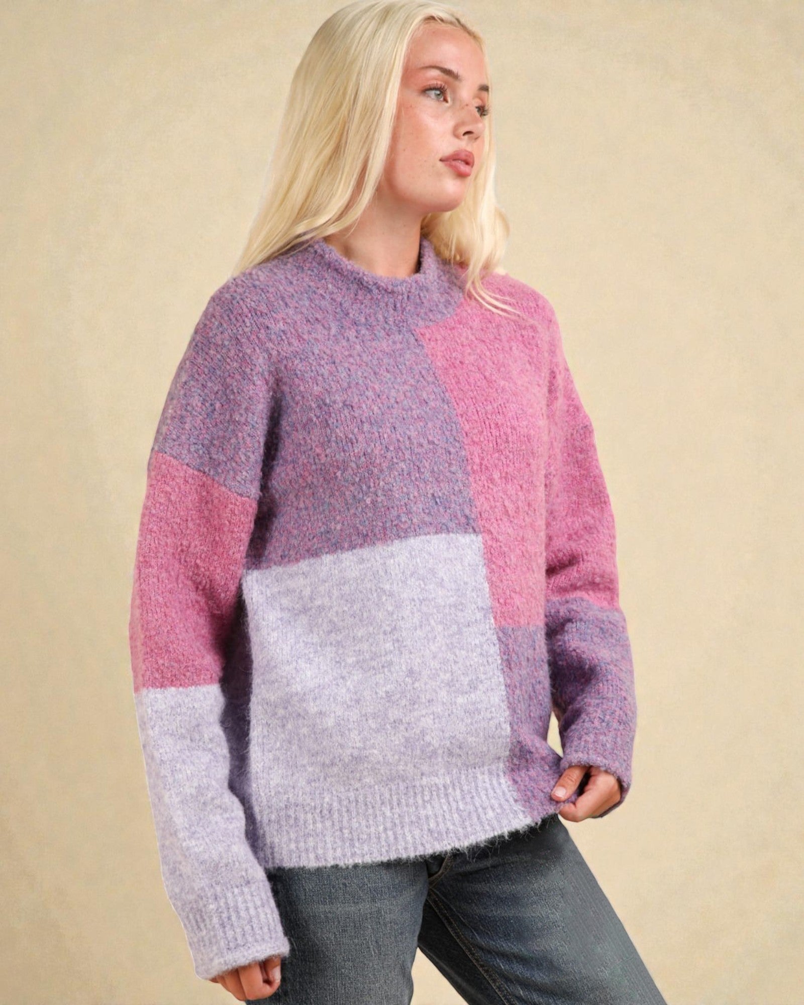 Woman wearing a colorful sweater with a beige background