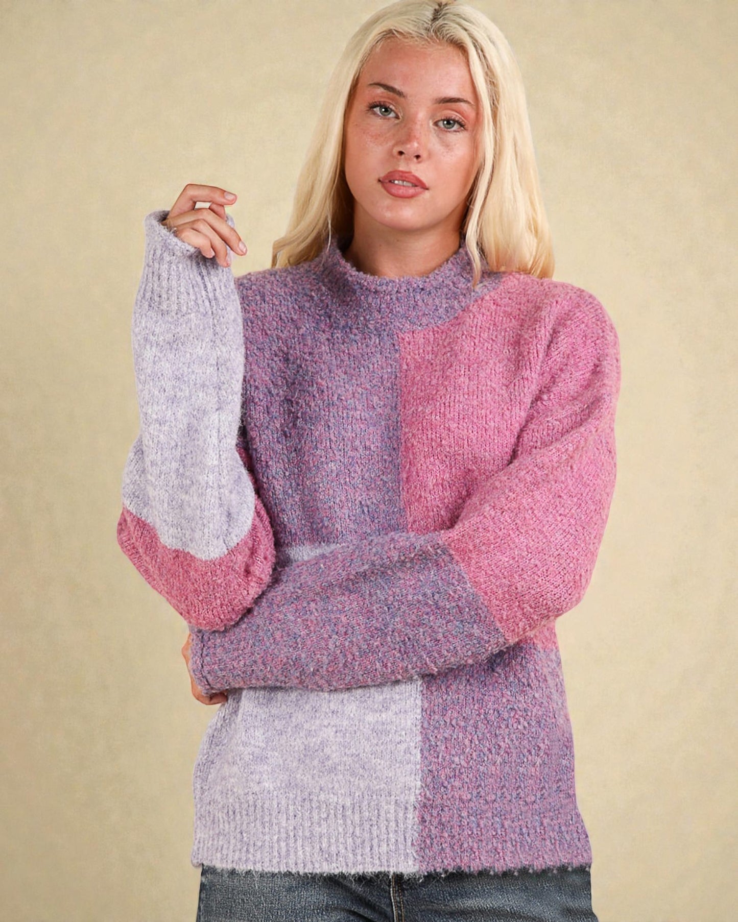 Woman wearing a colorful knit sweater against a beige background