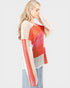 Woman wearing a colorful crochet top on a white background
