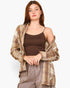 A woman modeling a brown ribbed camisole tank top, styled with an open beige and brown plaid flannel shirt and gray drawstring pants against a light gray background.