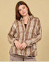 Woman wearing a plaid shirt against a beige background