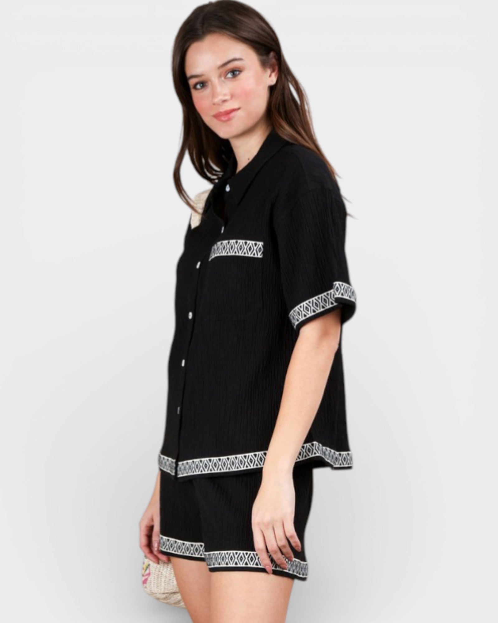 Black dress with white patterns on a plain background