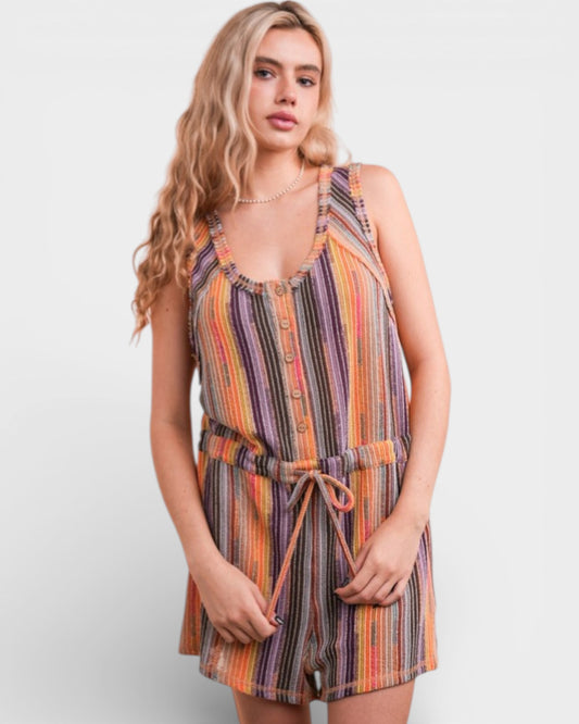 Woman wearing a colorful striped romper on a white background
