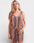 Woman wearing a colorful striped romper on a white background