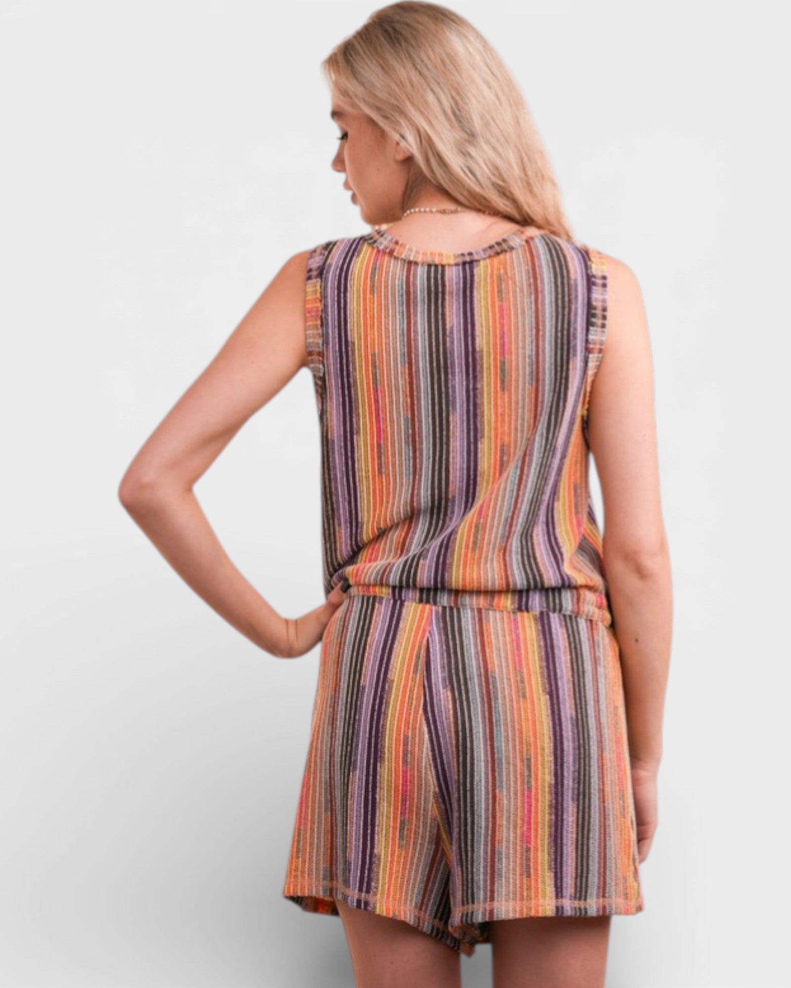 Woman wearing a colorful striped dress on a white background