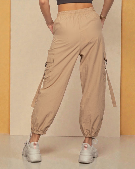 Beige cargo pants worn by a person on a neutral background