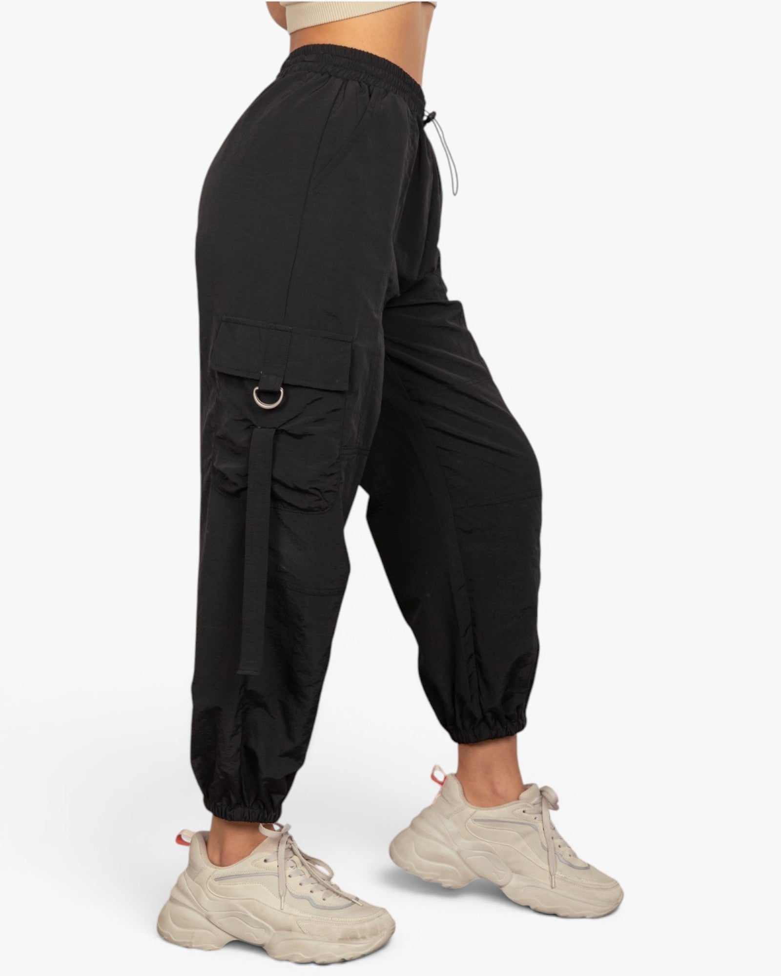 Black cargo jogger pants with a side flap pocket and drawstring waist, shown on a model from the side against a light gray background.
