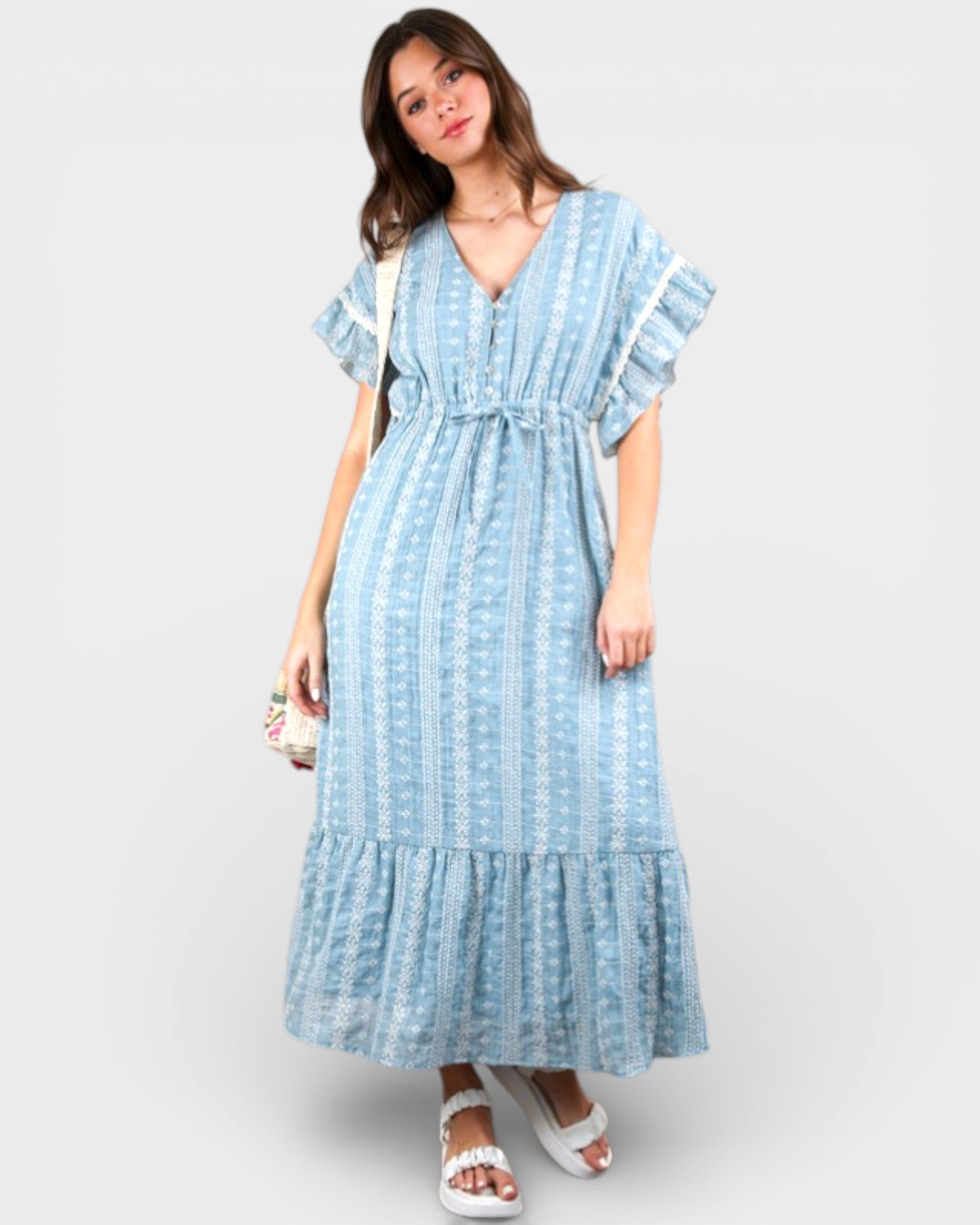 Woman wearing a blue patterned dress on a white background