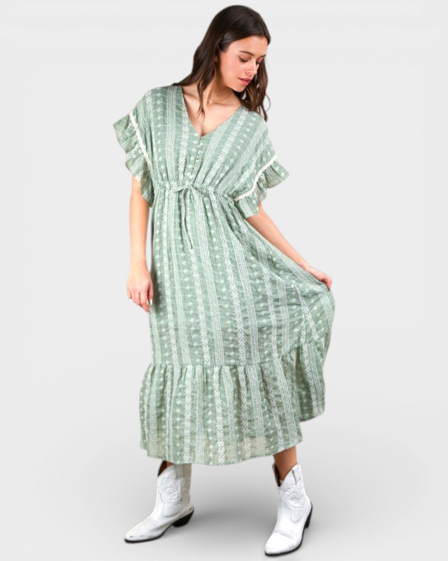 Woman wearing a green patterned dress on a white background