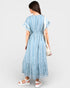 Woman wearing a blue and white striped dress on a plain background