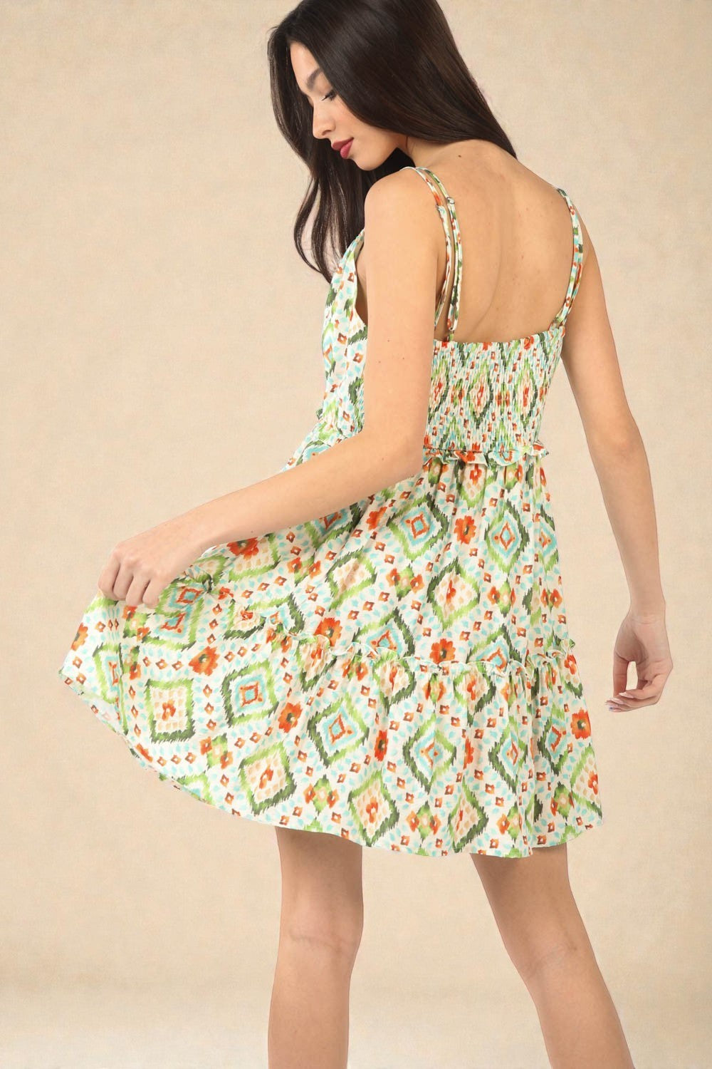 Woman wearing a floral dress against a beige background