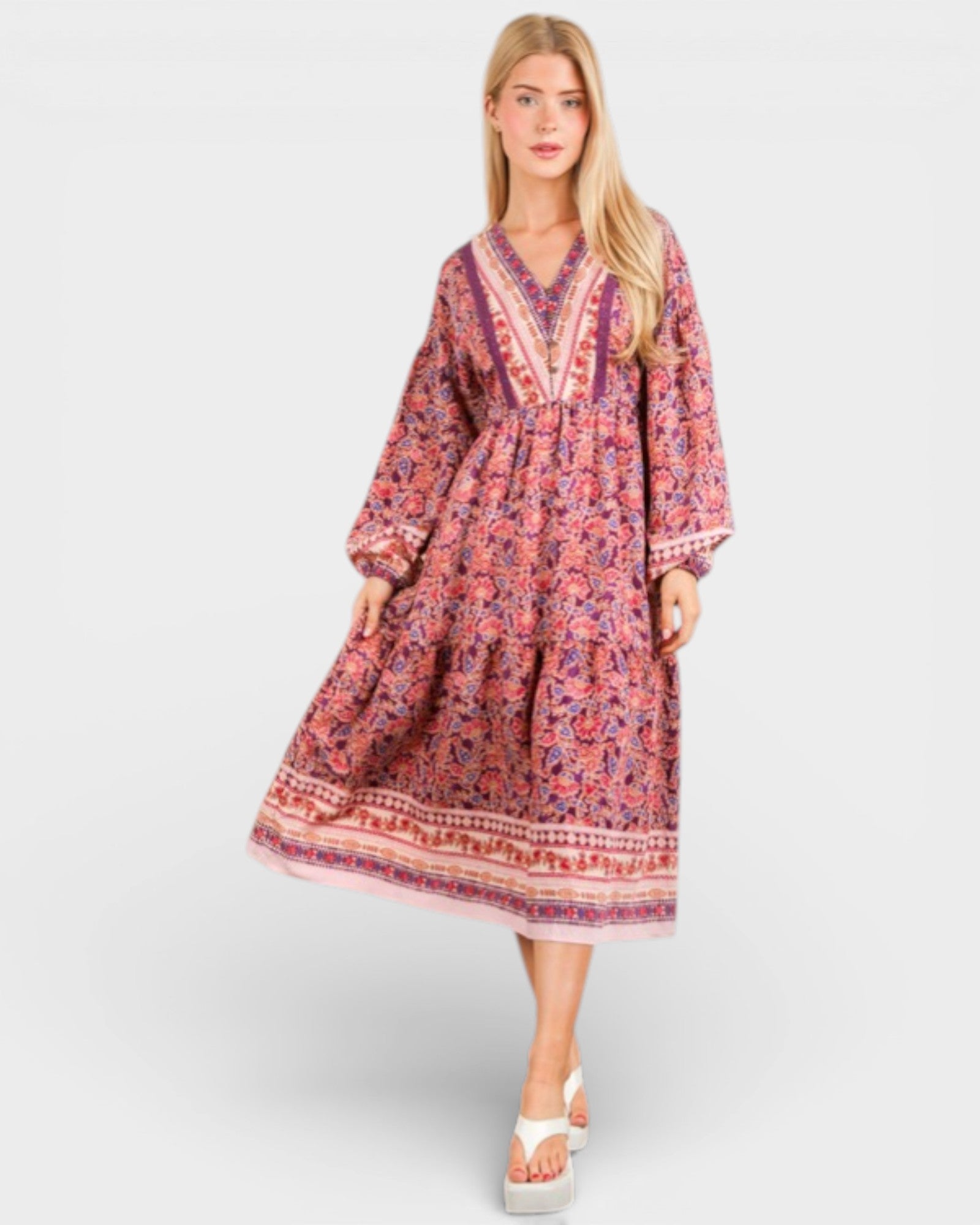 Woman wearing a patterned dress on a white background