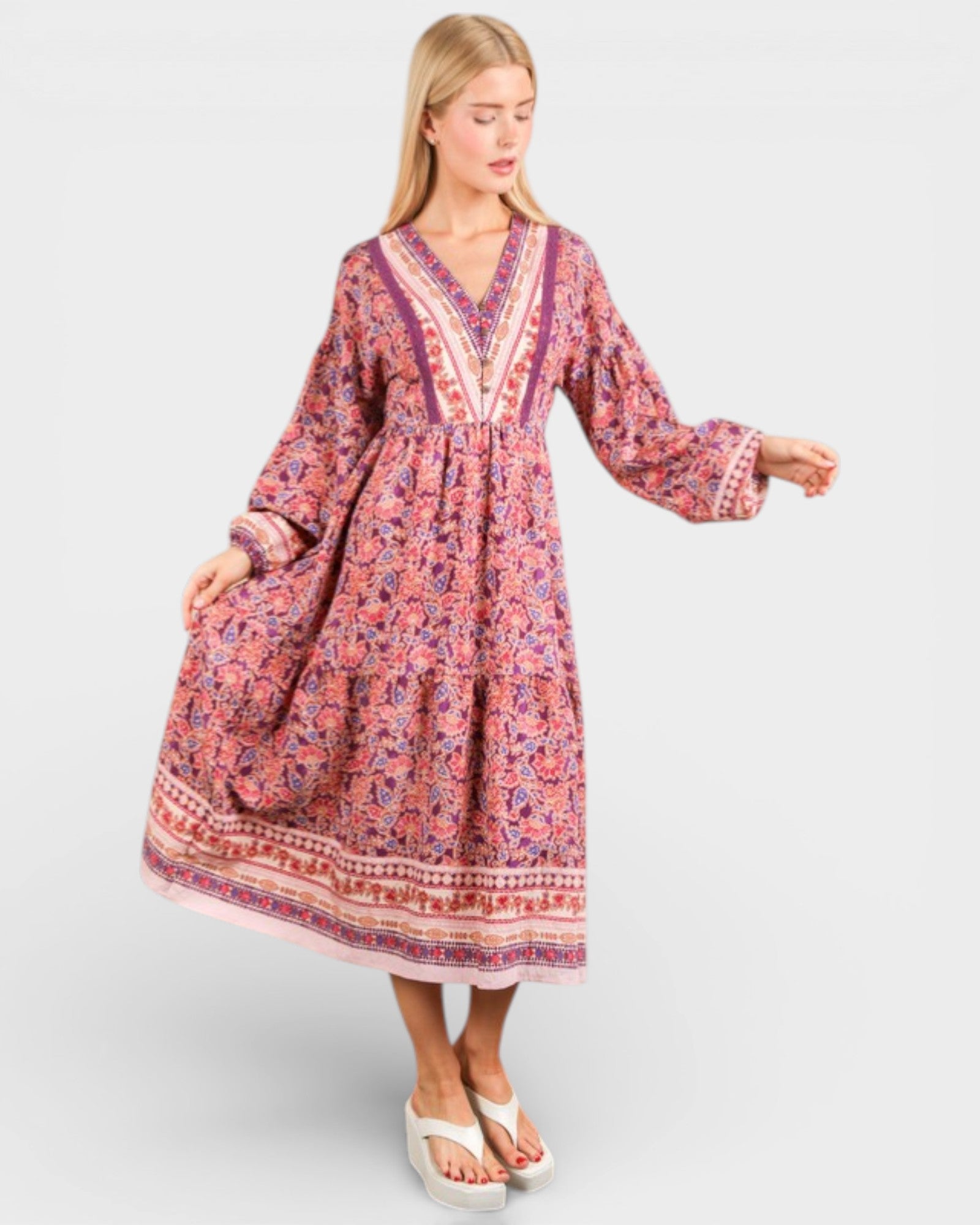 Woman wearing a patterned dress on a white background