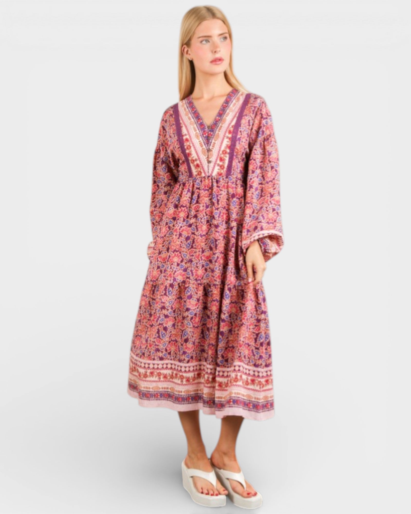 Woman wearing a patterned dress on a white background