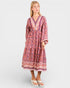 Woman wearing a patterned dress on a white background