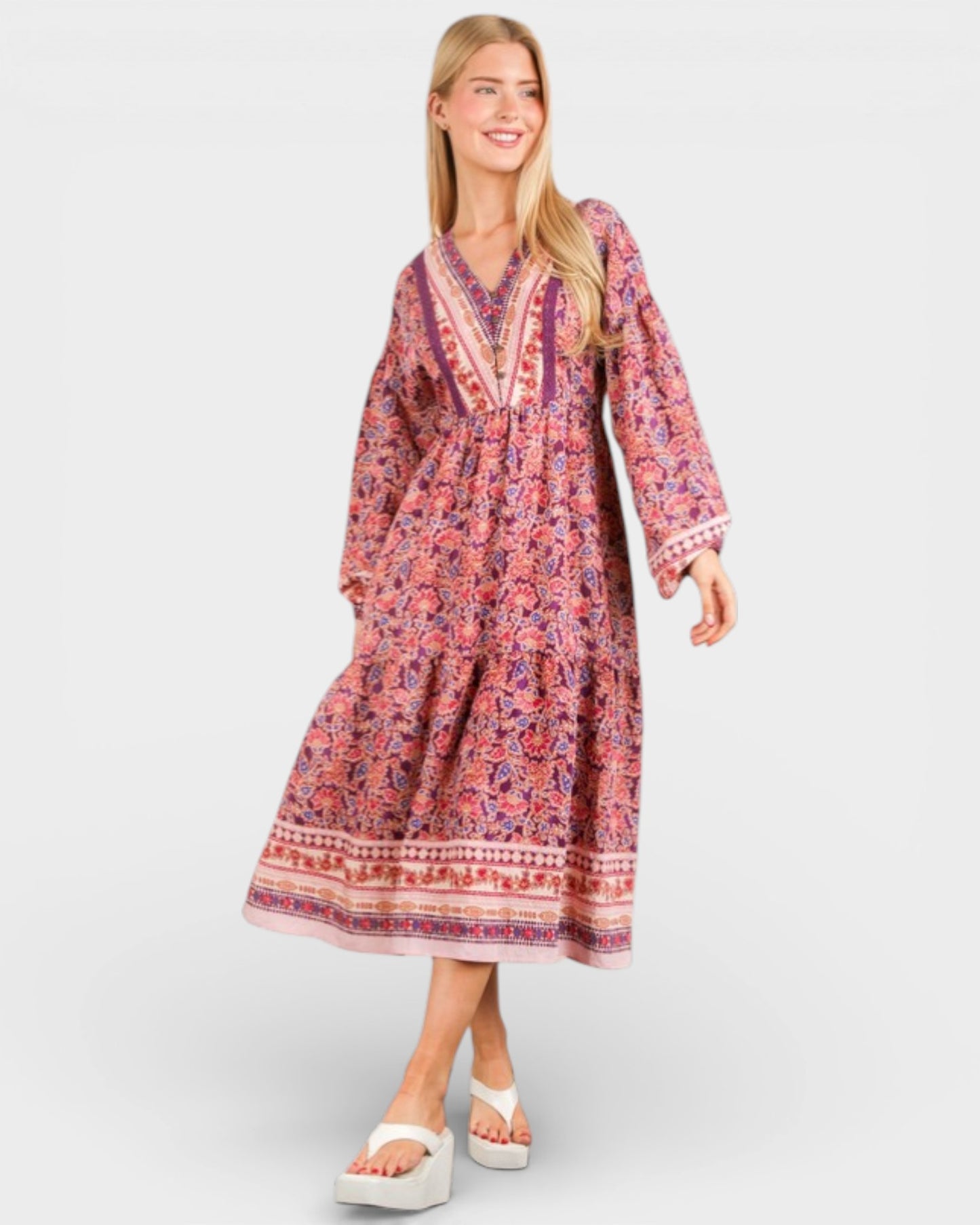 Woman wearing a patterned dress on a white background