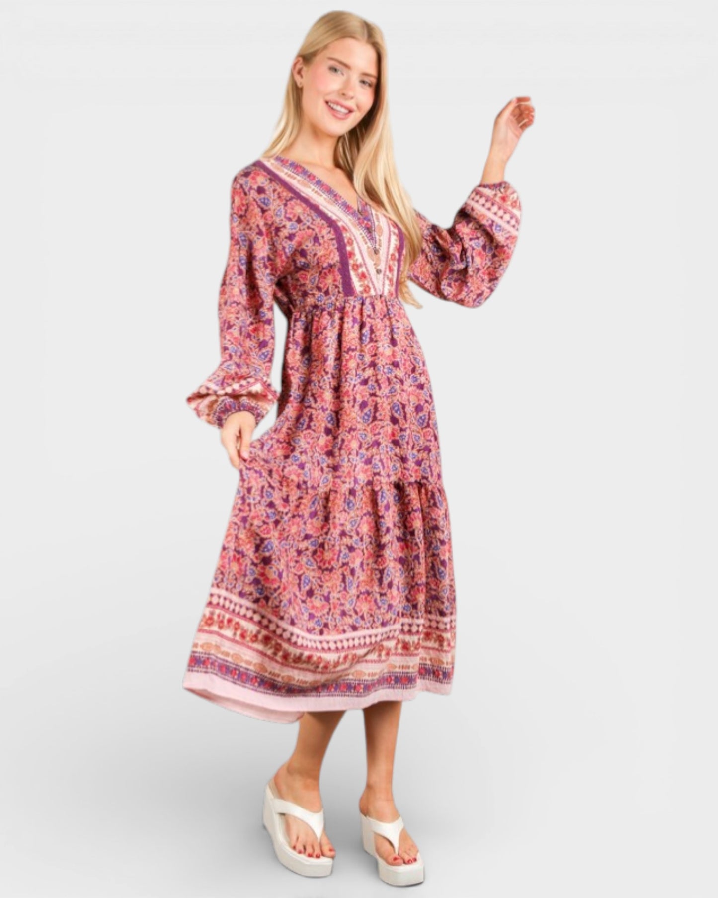 Woman wearing a patterned dress on a white background