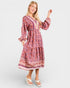 Woman wearing a patterned dress on a white background