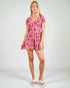Woman wearing a pink floral dress on a white background