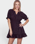 Woman wearing a black dress with puff sleeves on a white background