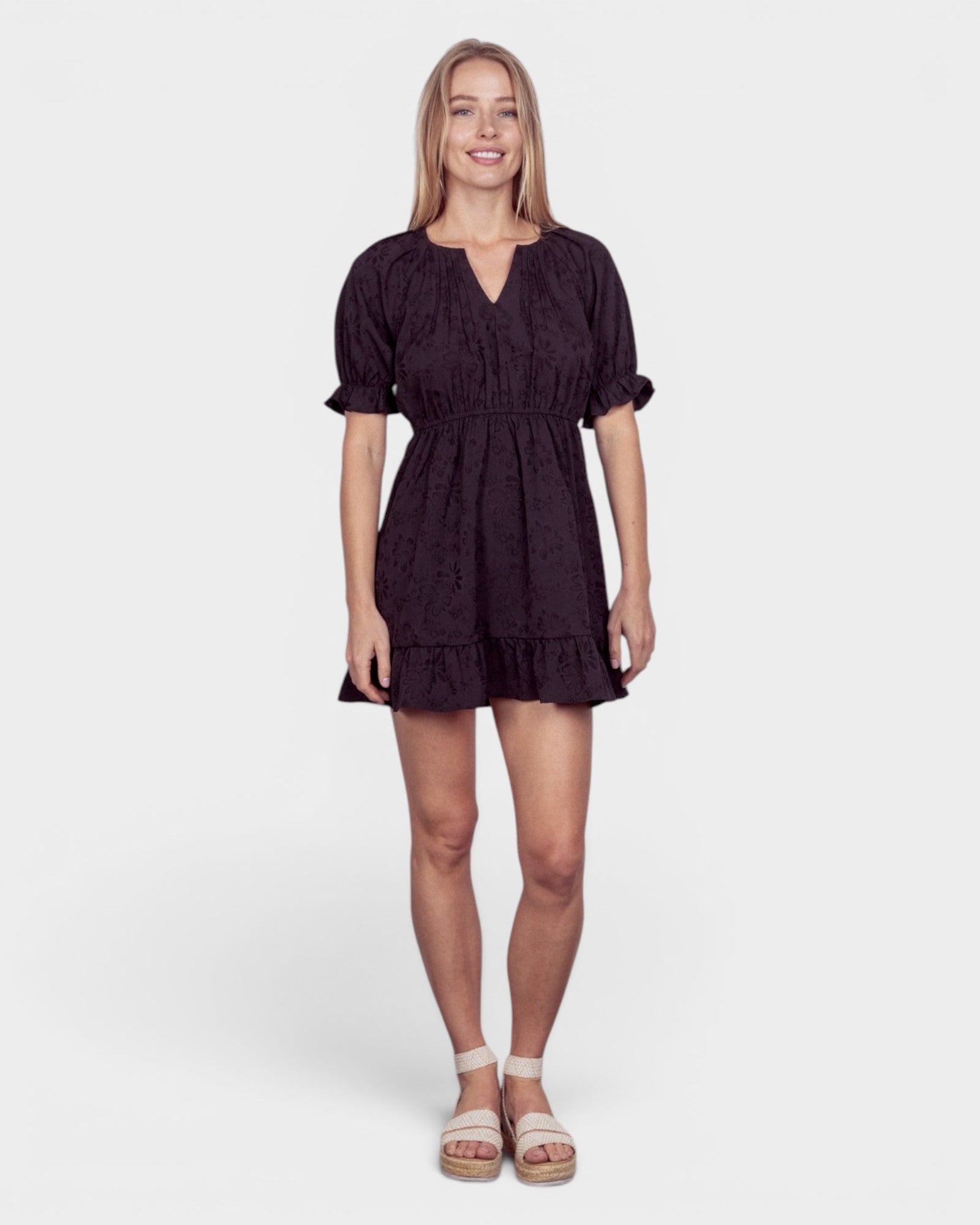 Woman wearing a black dress on a white background