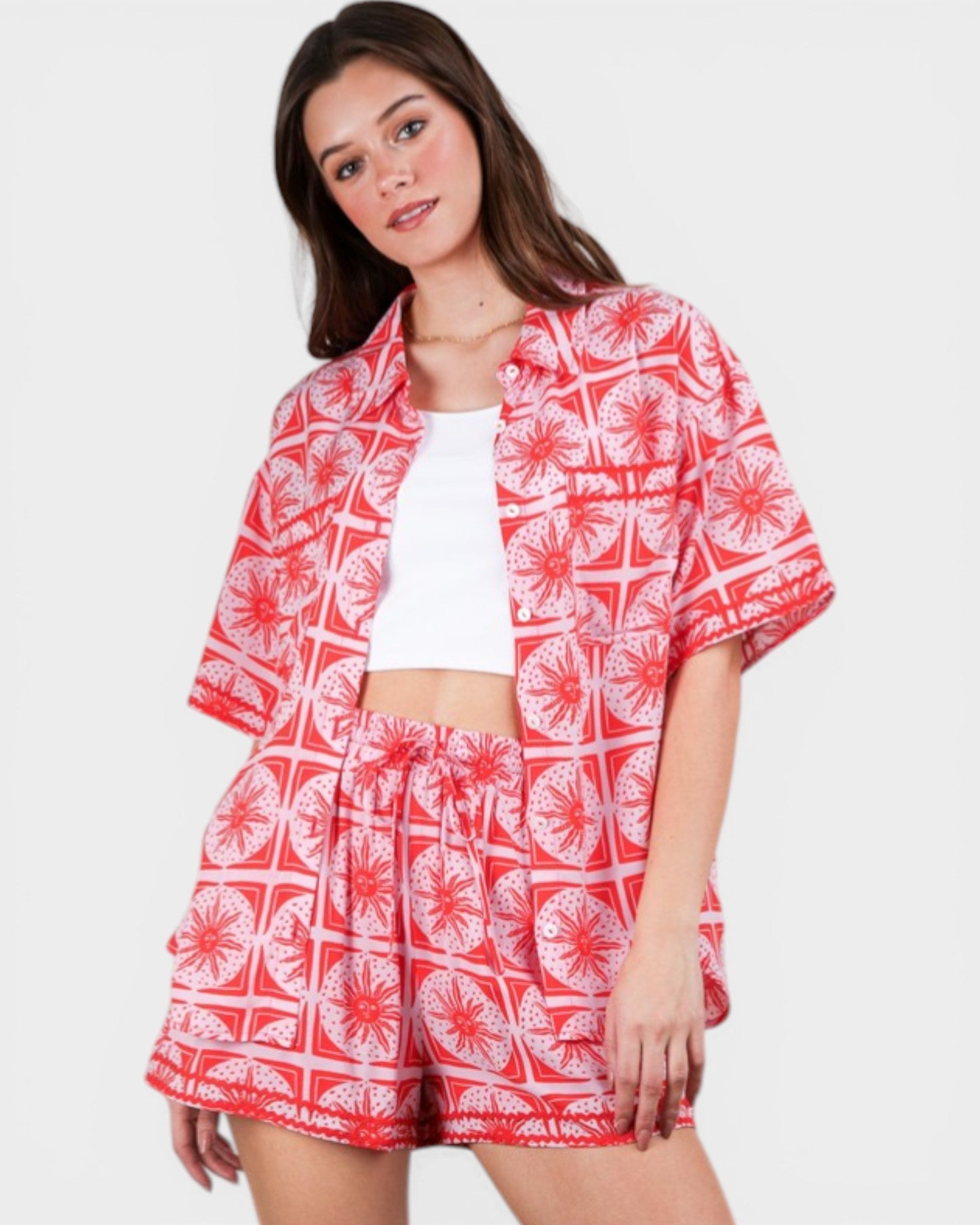 Woman wearing a red and white patterned outfit on a plain background