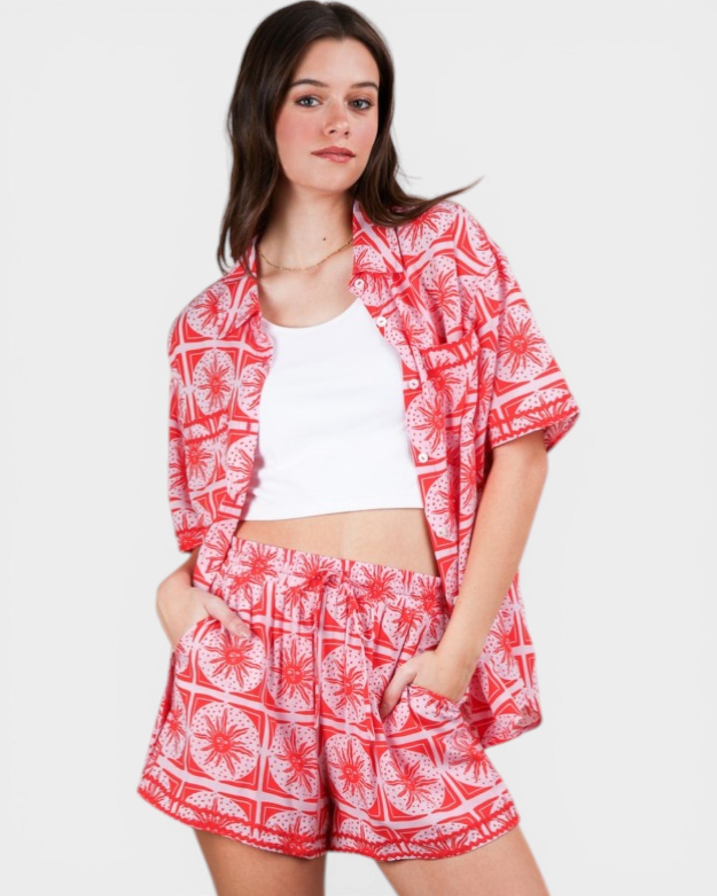 Woman wearing a red and white patterned outfit on a white background