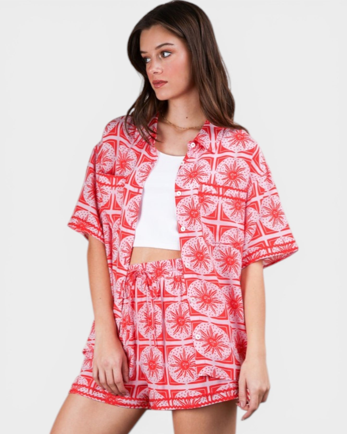Woman wearing a red and white patterned outfit on a plain background