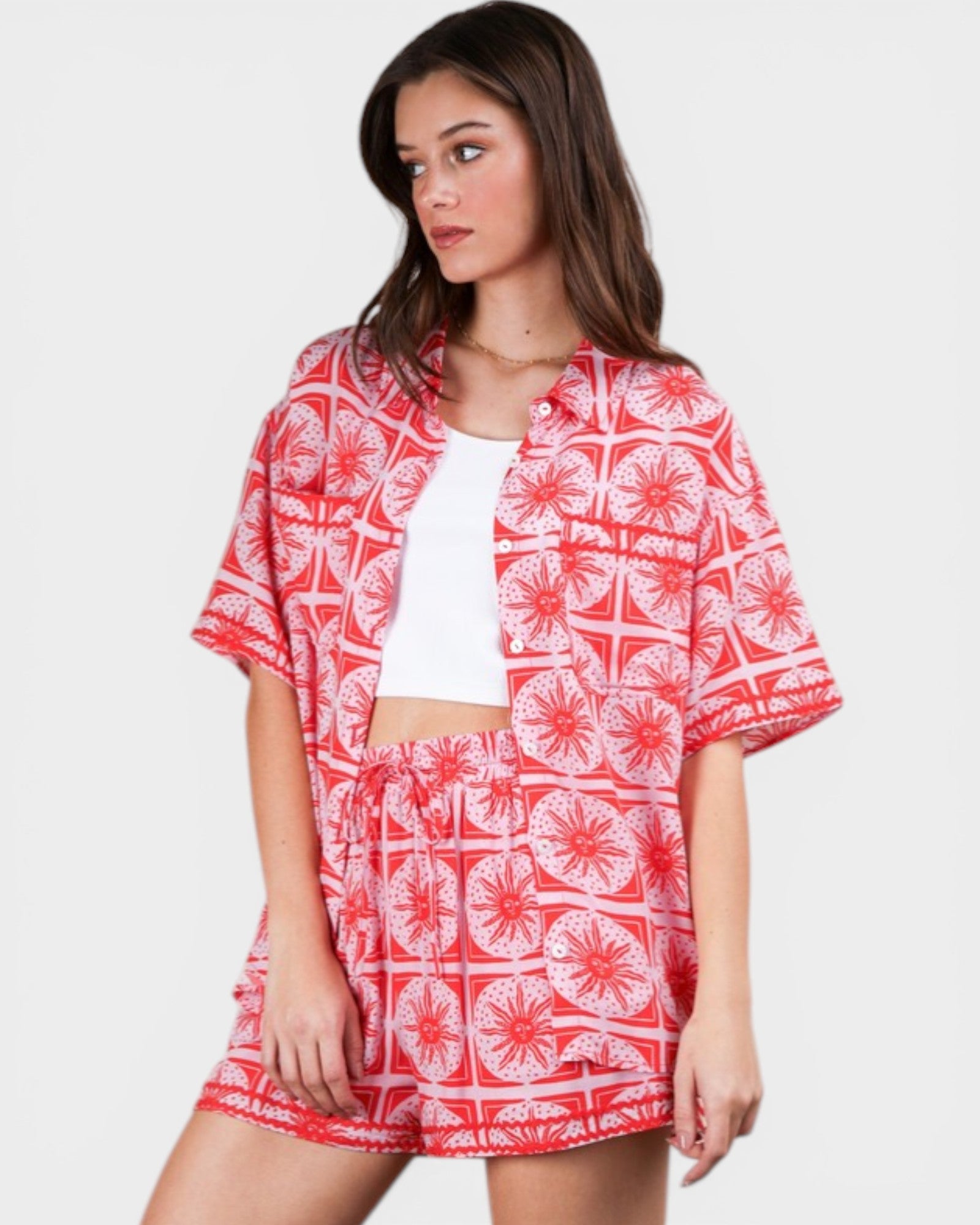 Woman wearing a red and white patterned outfit on a plain background