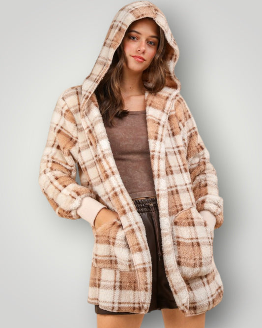 Person wearing a plaid hoodie against a plain background