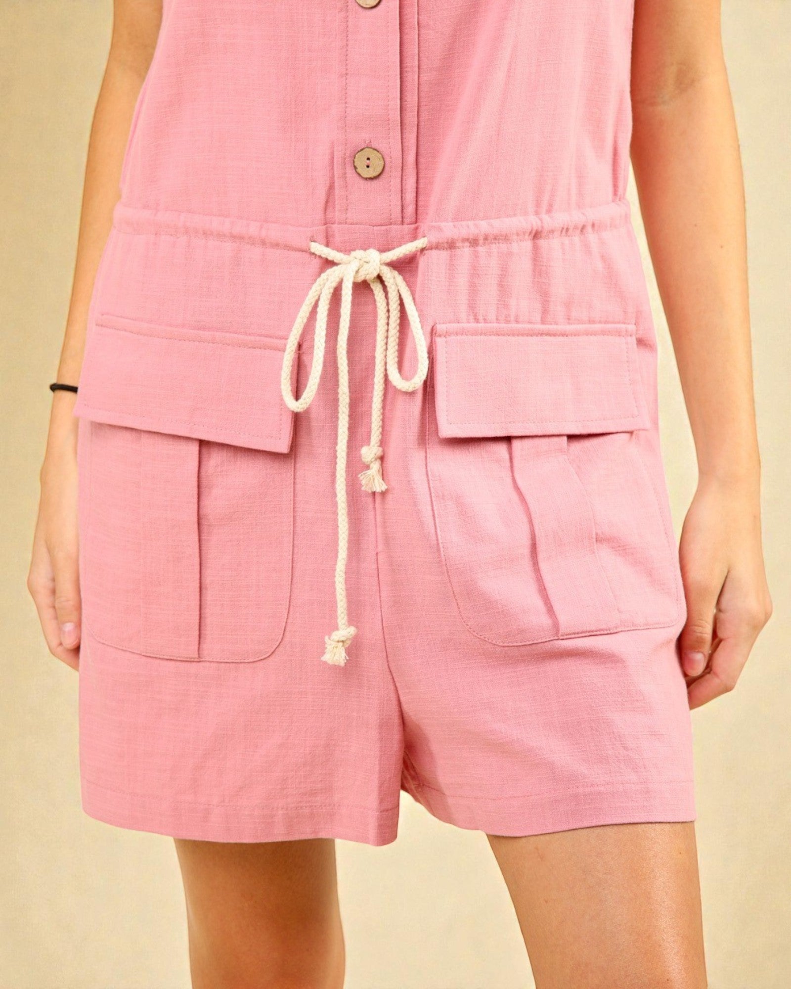 Pink shorts with a drawstring on a beige background