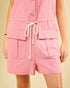 Pink shorts with a drawstring on a beige background