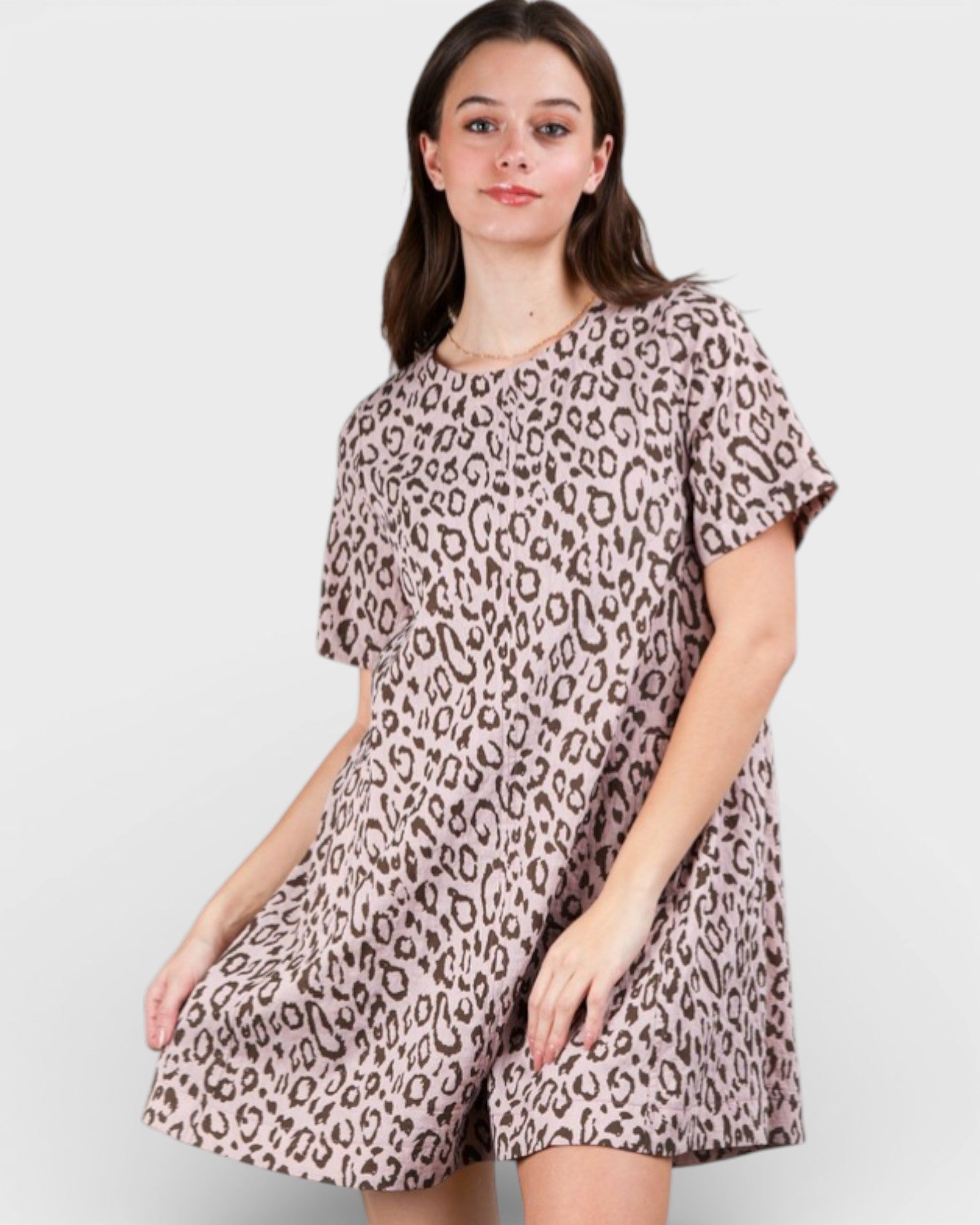 Woman wearing a leopard print dress on a white background