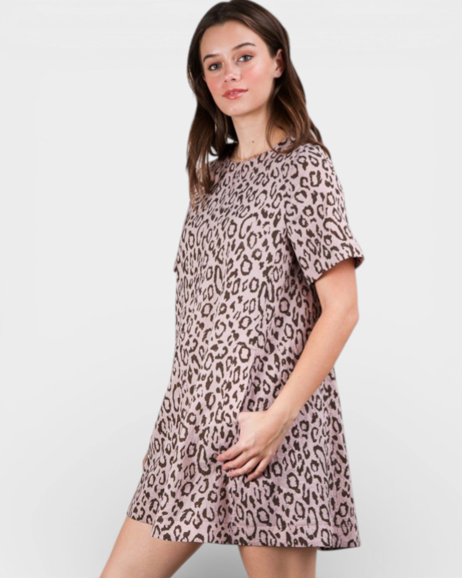 Woman wearing a leopard print dress on a white background