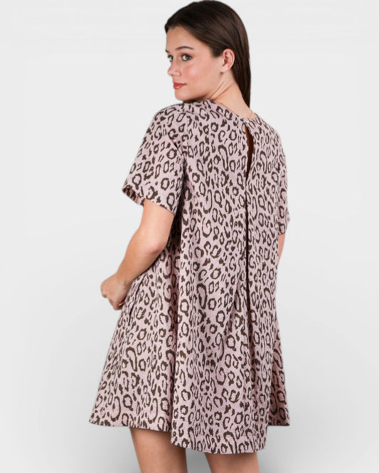 Woman wearing a leopard print dress on a white background