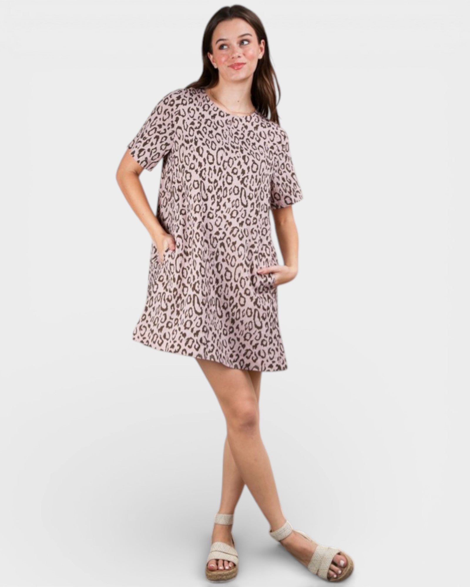 Woman wearing a leopard print dress on a white background