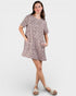 Woman wearing a leopard print dress on a white background