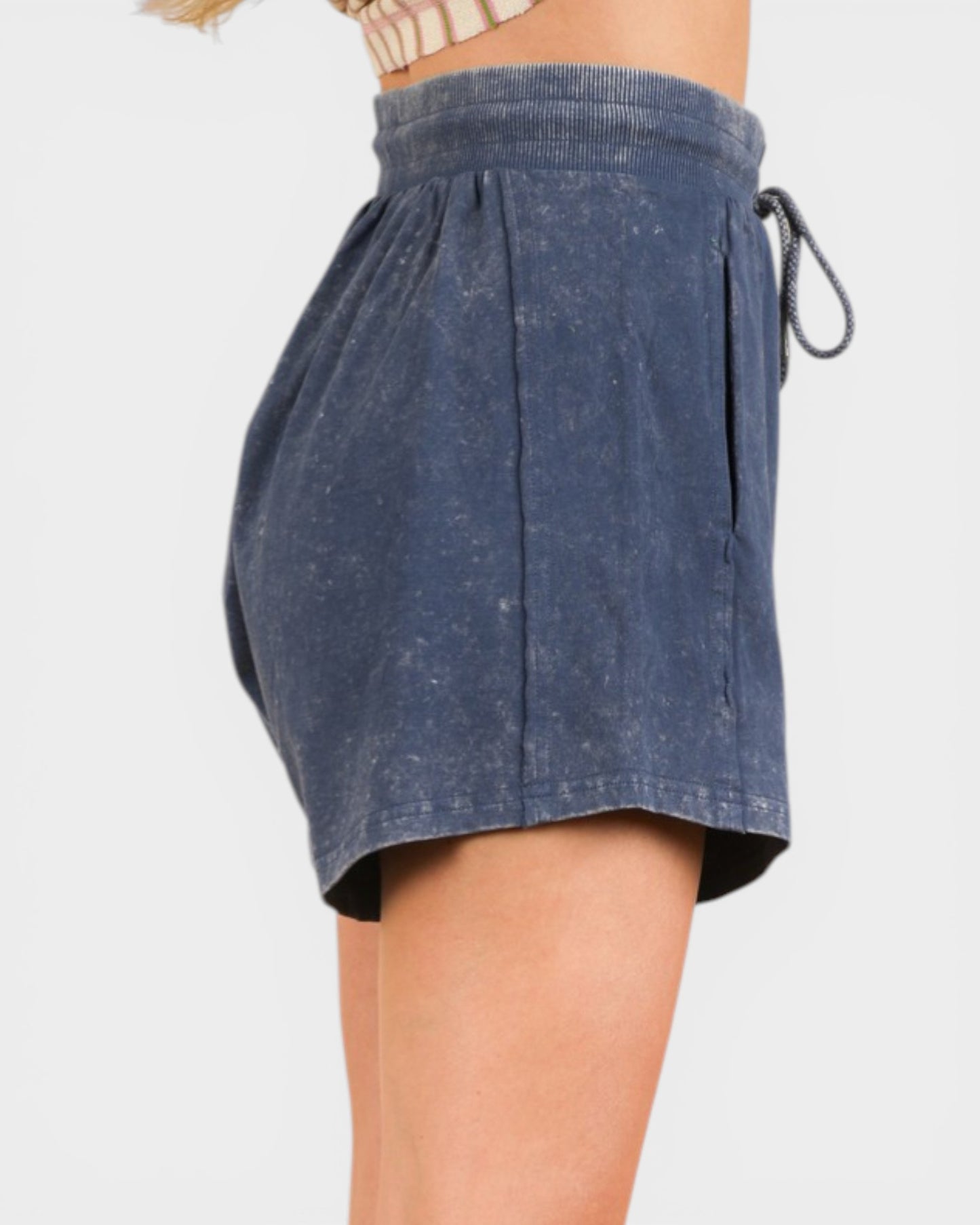Blue denim shorts with drawstring on a white background