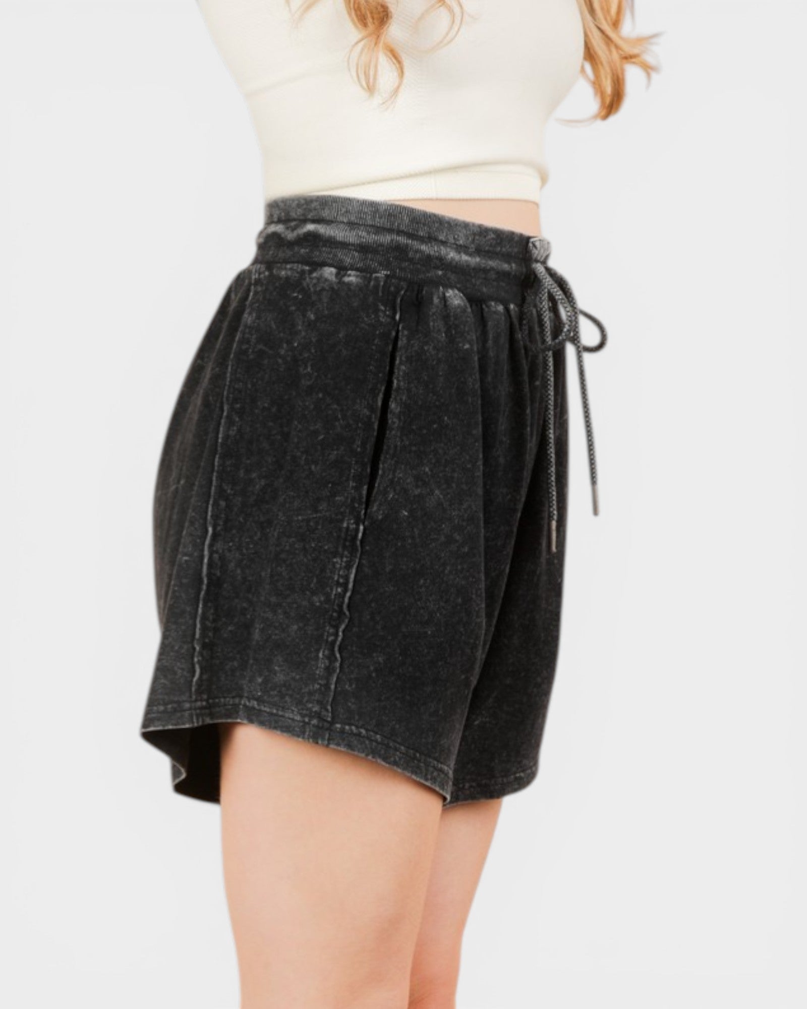 Black denim skirt worn by a person on a white background