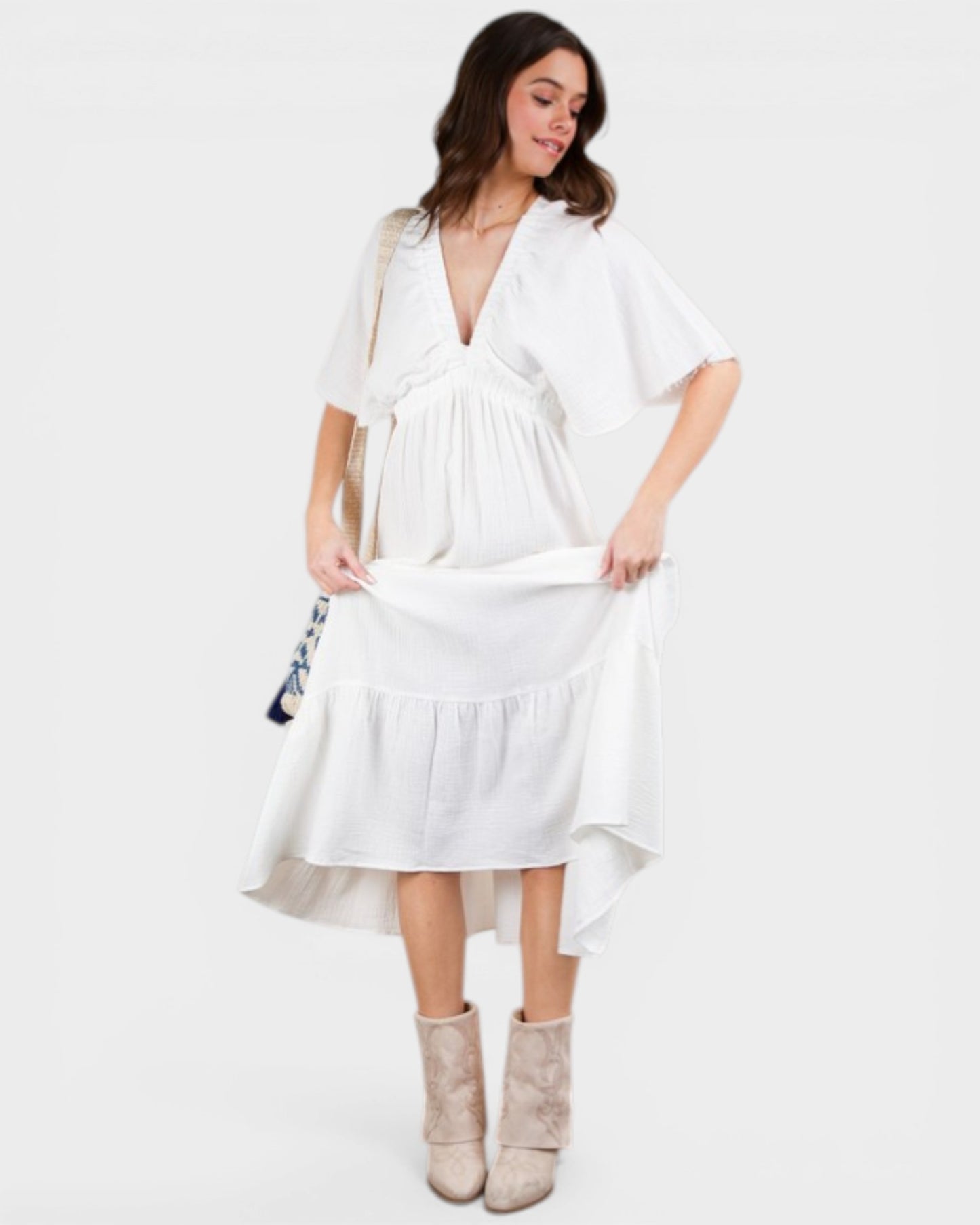 Woman wearing a white dress with a plain background