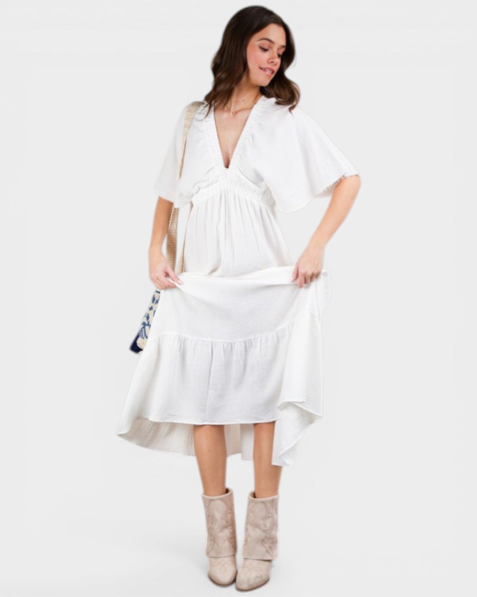 Woman wearing a white dress with a plain background