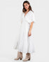 Woman wearing a white dress with a plain background